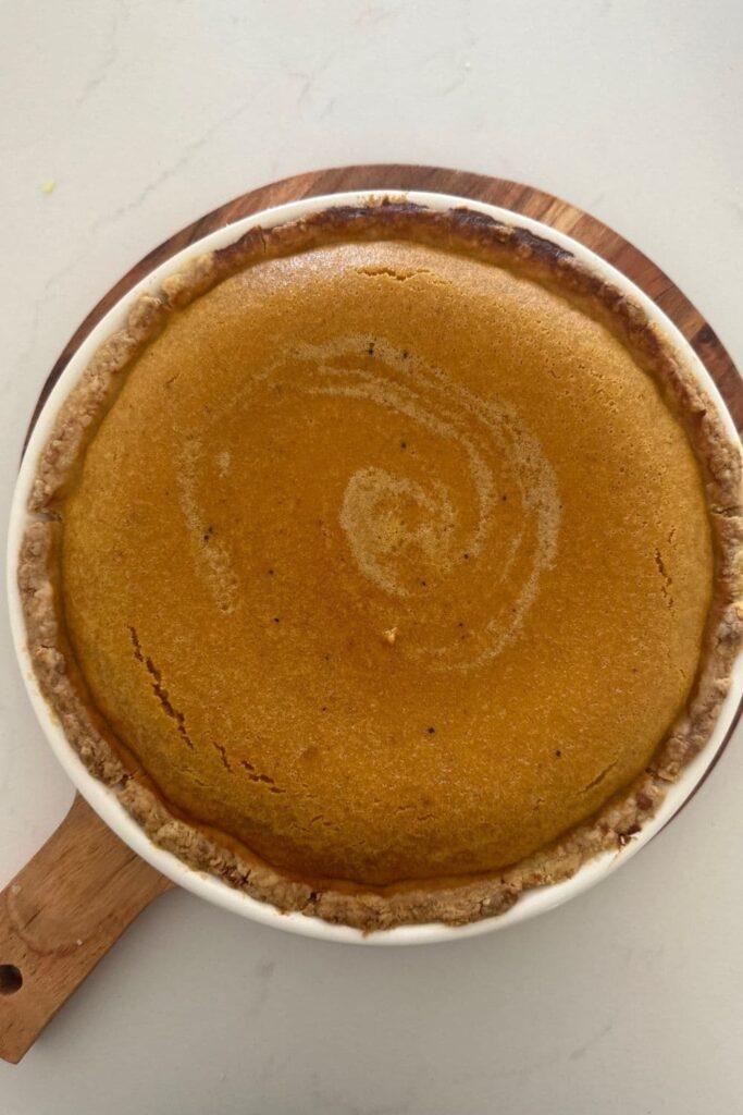 A sourdough pumpkin pie fresh out of the oven. The filling is still puffed up a little.