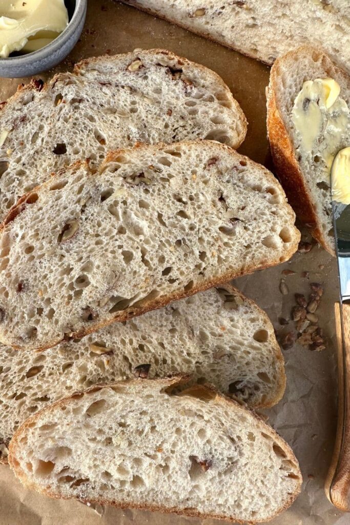 Slices of high protein sourdough bread laid out on a piece of parchment paper.