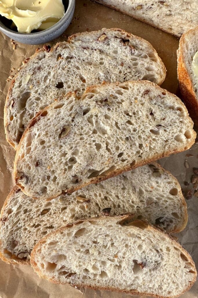 Slices of high protein sourdough bread laid out on a piece of parchment paper.