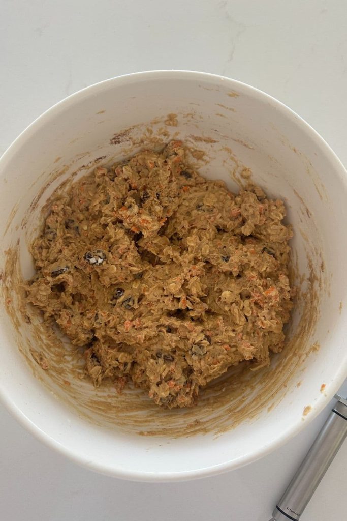 A bowl of sourdough carrot cake cookie dough that has been fermented in the fridge.