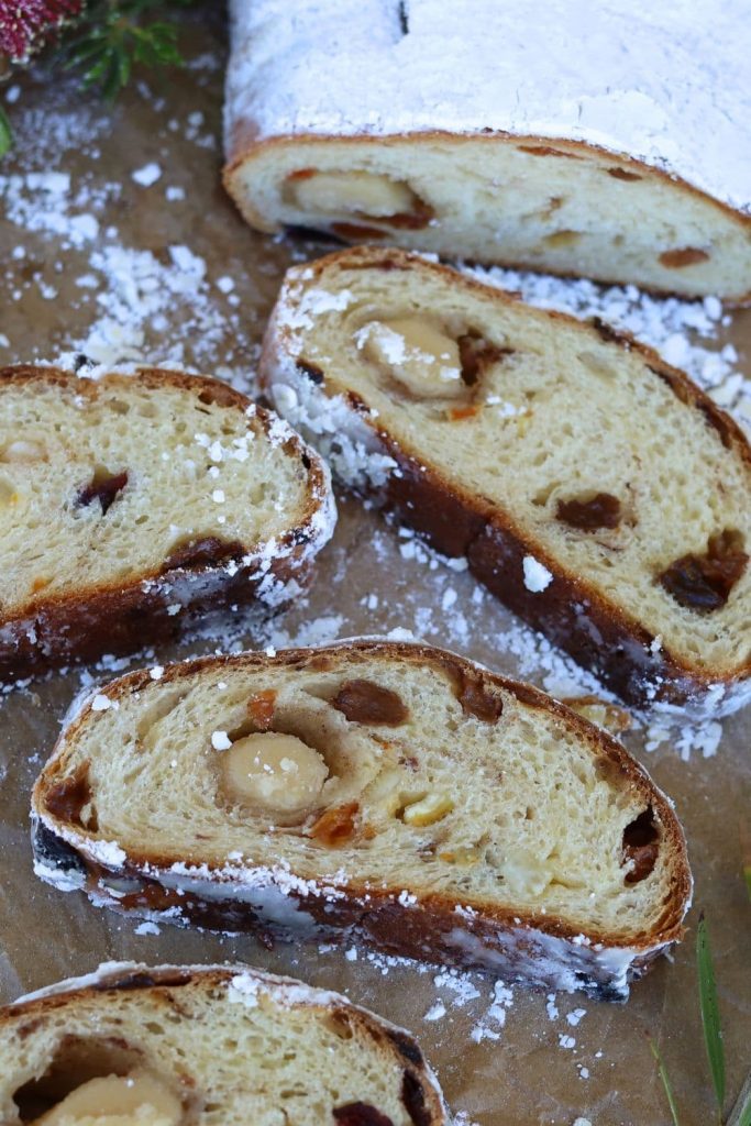 Sourdough stollen sliced up. The slices have been laid out so you can see the marzipan and fruit inisde this traditional German Christmas bread.