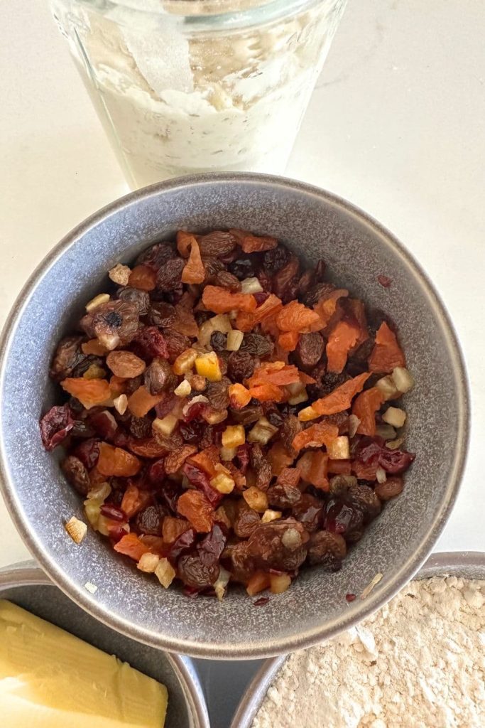 A bowl of dried fruit soaked in rum used in making sourdough stollen bread.
