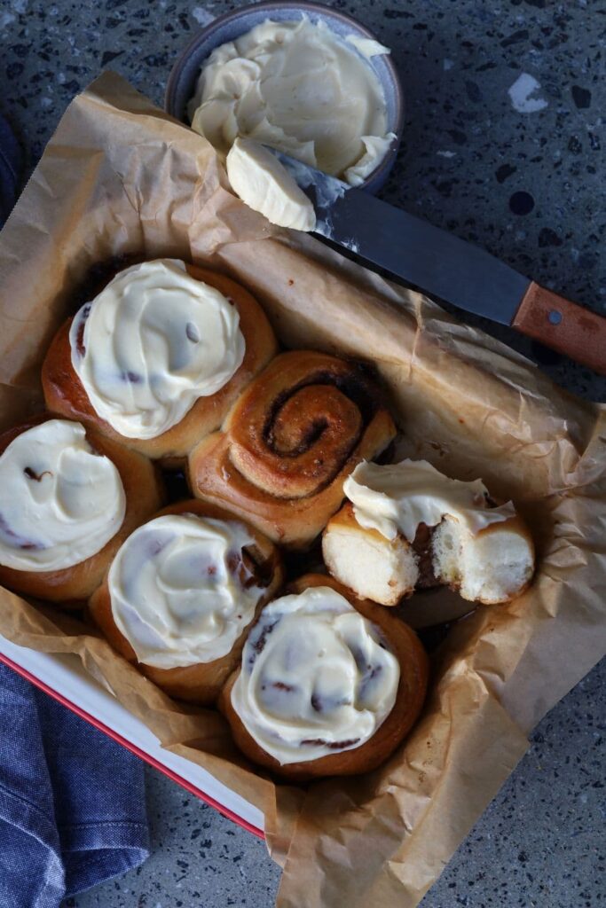 Sourdough cinnamon rolls topped with vanilla cream cheese frosting.