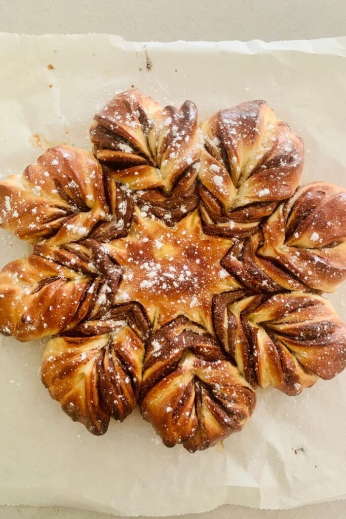 A sourdough chocolate star bread dusted in powdered sugar.