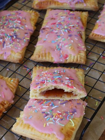 Strawberry sourdough pop tarts topped with strawberry frosting and sprinkles.