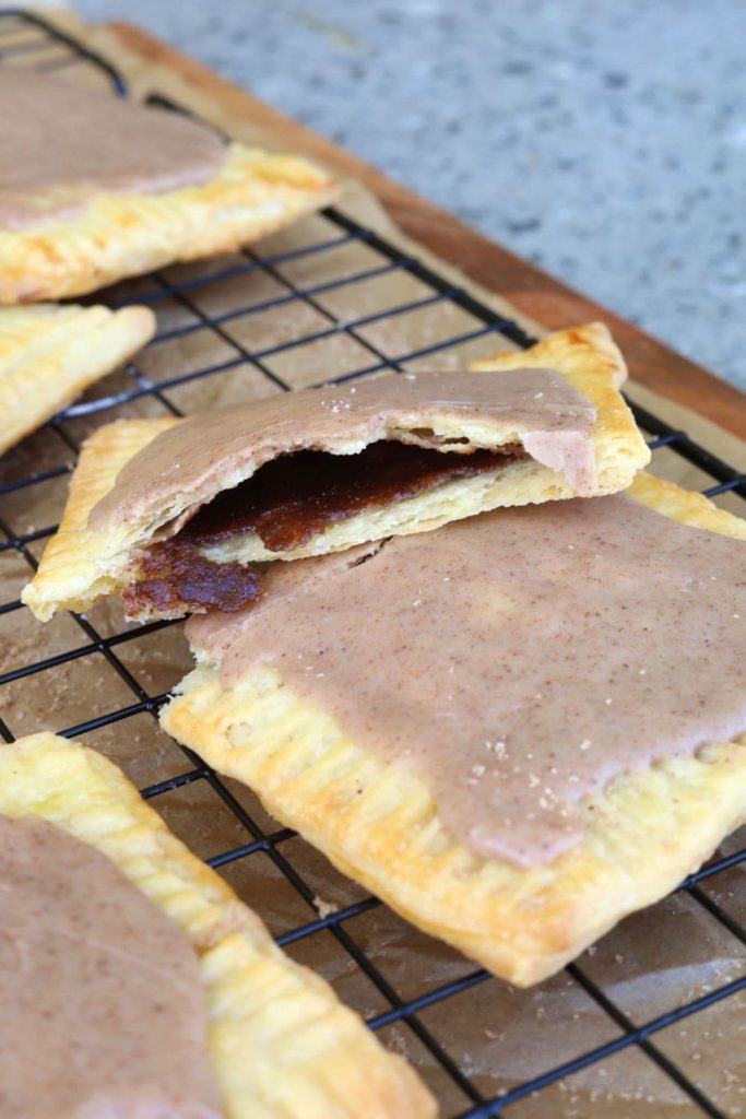 Sourdough pop tarts filled with brown sugar cinnamon filling and cinnamon frosting on top.