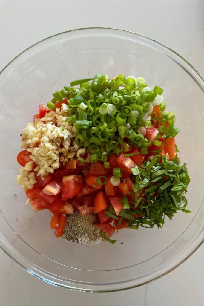 A bowl of ingredients needed to make sourdough bruschetta.