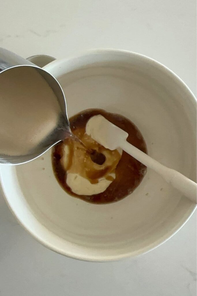 Guinness beer being poured into a bowl of sourdough starter.