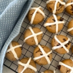 Sourdough hot cross cookies for Easter displayed on a black wire cooling rack. Recipe Feature Image