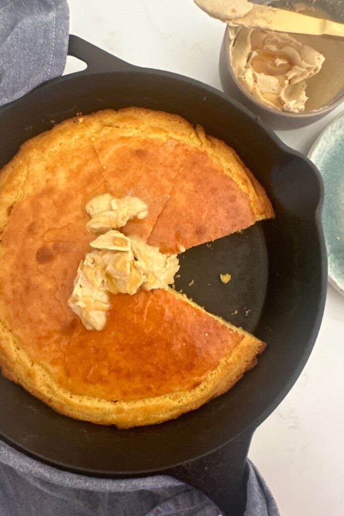 Sourdough cornbread baked in a skillet and served with whipped honey cinnamon butter.