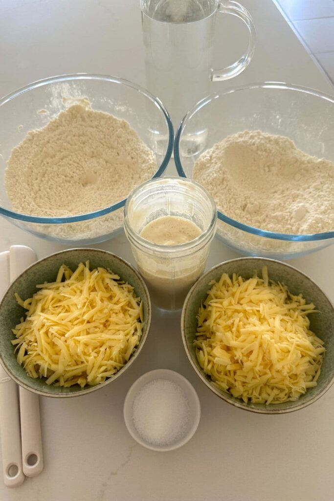 Ingredients necessary to make golden sourdough cheese bread.