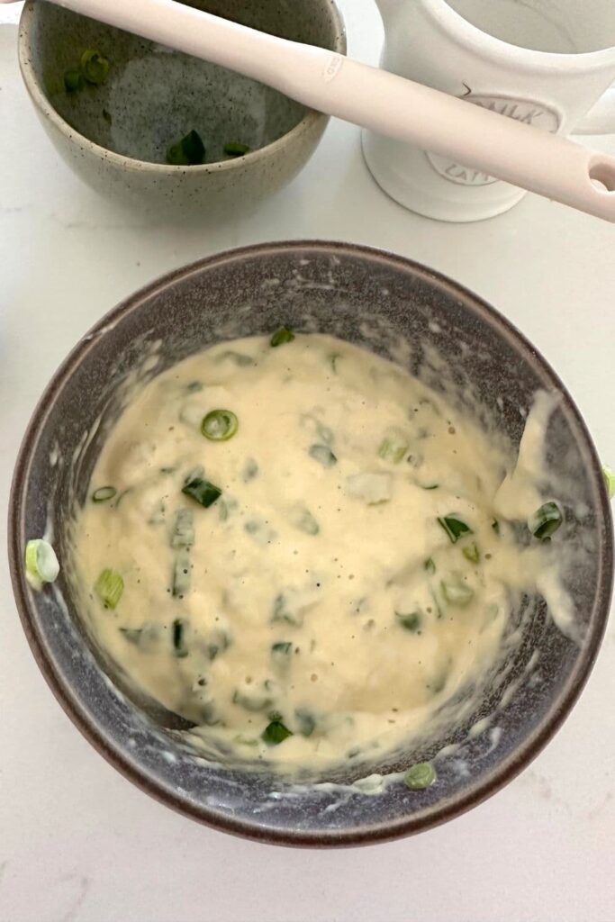 A bowl of batter made to make sourdough discard scallion pancakes.