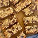 A selection of baked sourdough granola bars displayed on a wooden board.