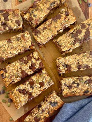 A selection of baked sourdough granola bars displayed on a wooden board.