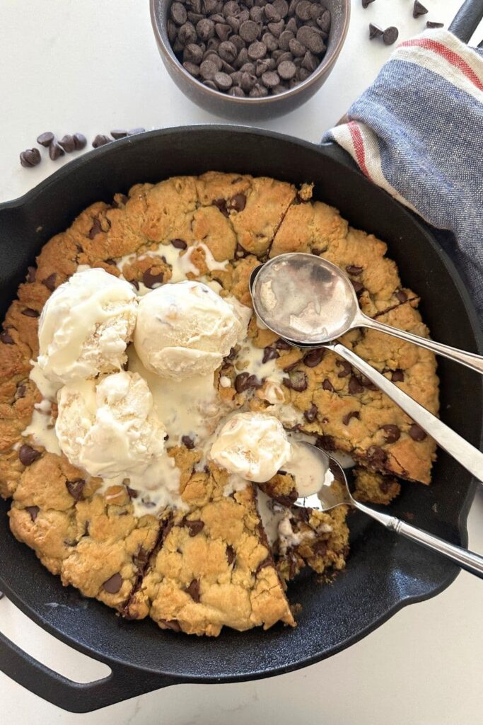 Sourdough chocolate chip skillet cookie topped with vanilla ice cream.