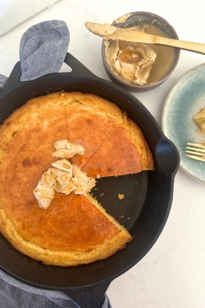 Sourdough skillet cornbread topped with honey cinnamon butter.