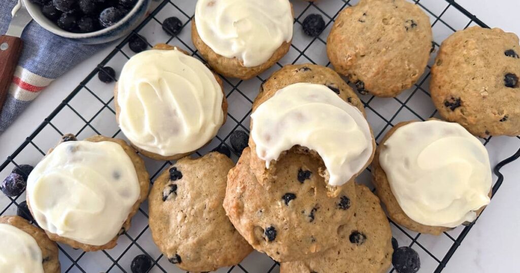 Sourdough blueberry cookies baked and topped with a lemon cream cheese frosting.