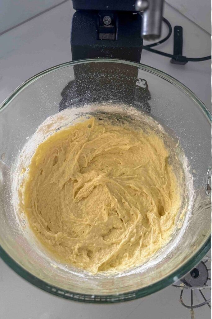 All ingredients mixed in glass mixing bowl for sourdough pound cake recipe.