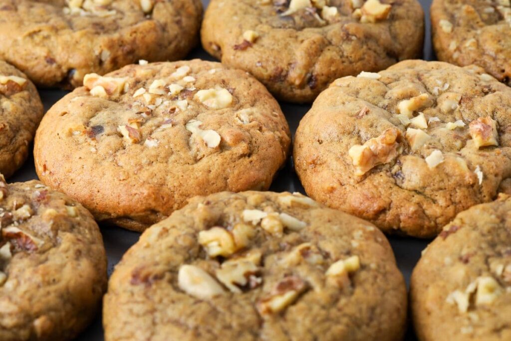 Close up of sourdough date and walnut cookies to show soft and chewy texture.