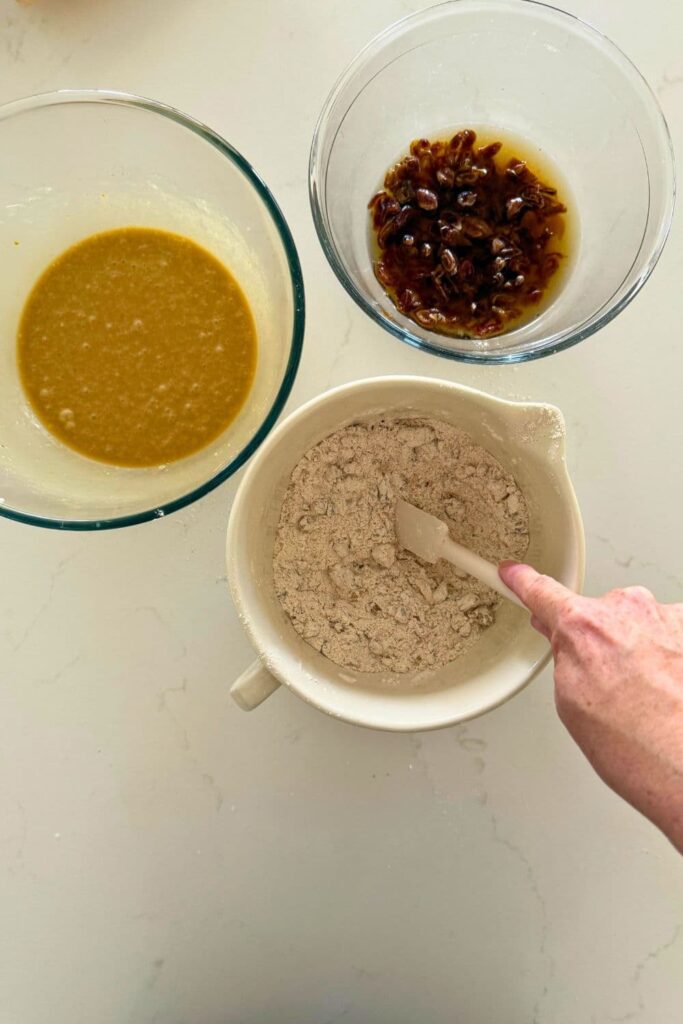 Mixing the dry ingredients to make sourdough date and walnut loaf cake.