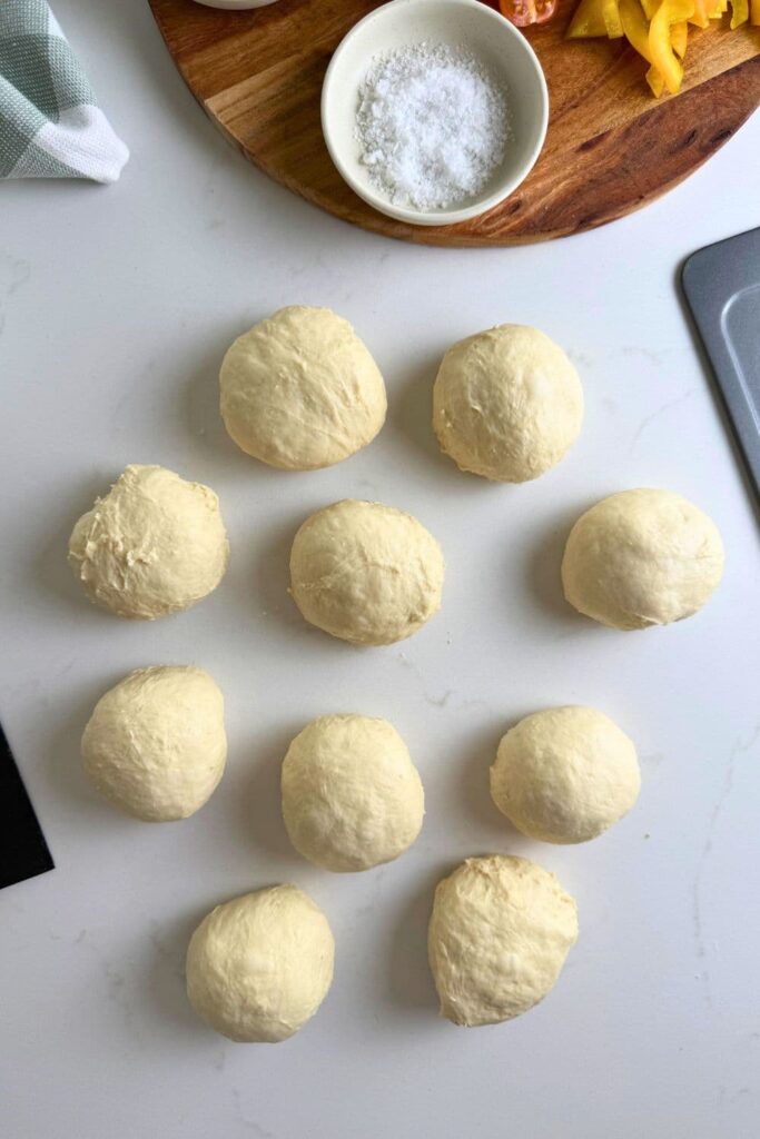 Measured out dough on counter to make sourdough focaccia rolls.