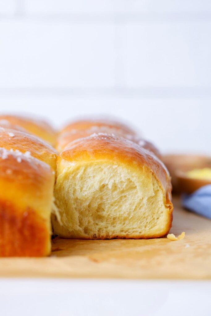 Side view of a sourdough discard honey butter rolls.