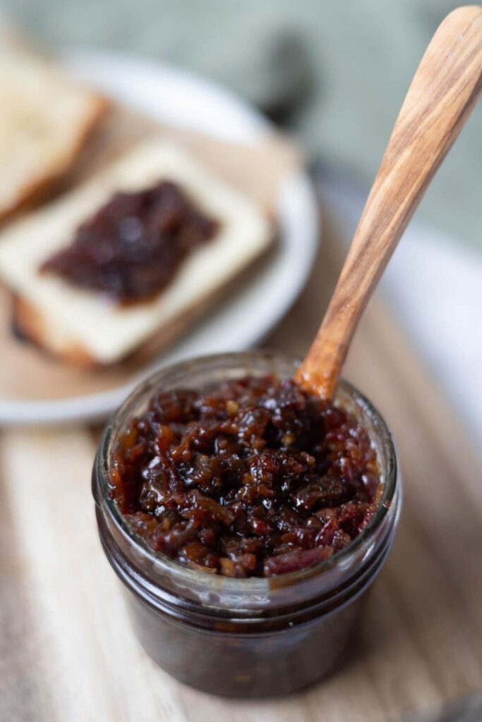 Close up image of bacon jam in a jar to show the texture.