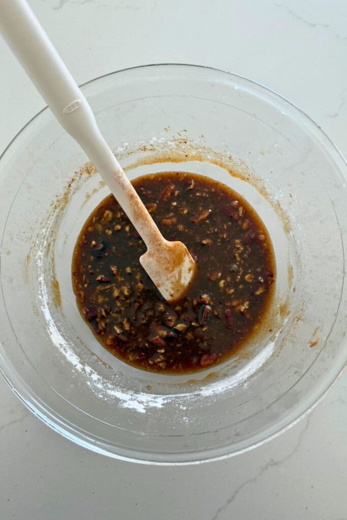 Mixing the filling in a bowl to make a sourdough maple pecan twist loaf.