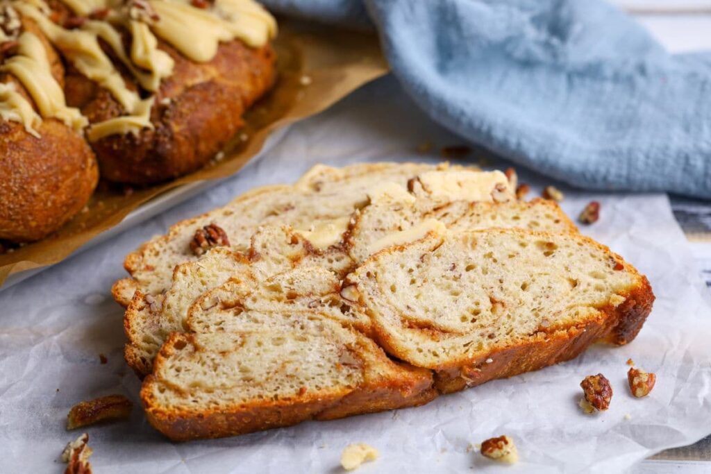 Close up of a slice of a sourdough maple pecan twist loaf.
